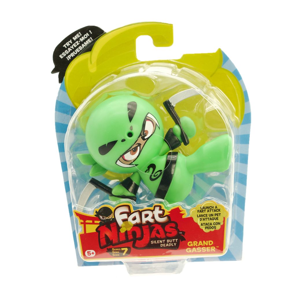 Fart Ninjas toy in packaging. The character is green, holding two weapons, and has an angry expression. The package reads 'Fart Ninjas – Silent But Deadly, Grand Gasser' and includes a try-me button.
