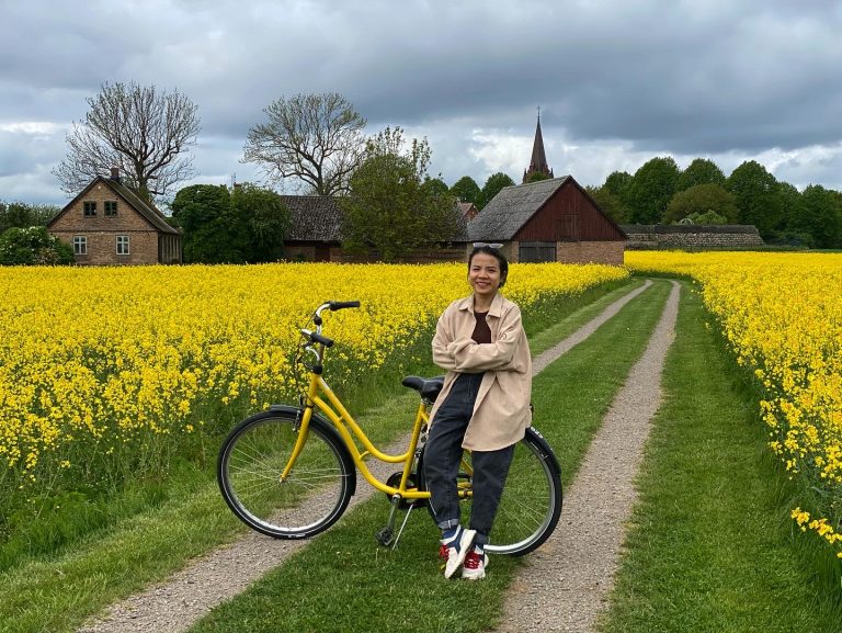Software developer Nhung Nguyen in a field of flowers