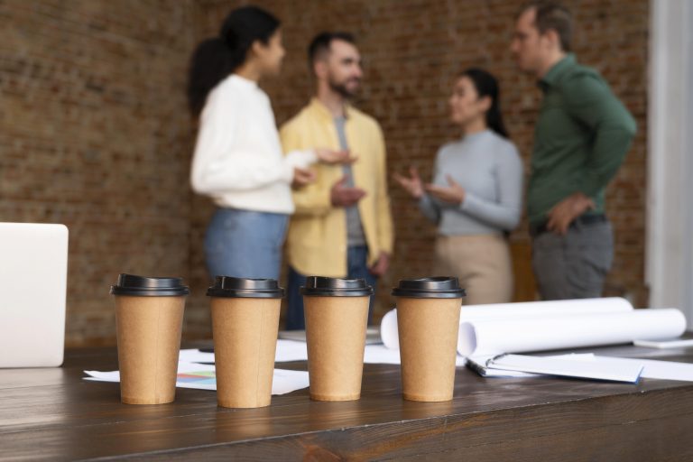When Appearances Beat Results: Coffee Badging, Green Status Effect, and Other Performative Displays in the Workplace Software developers chat during a coffee break in an office