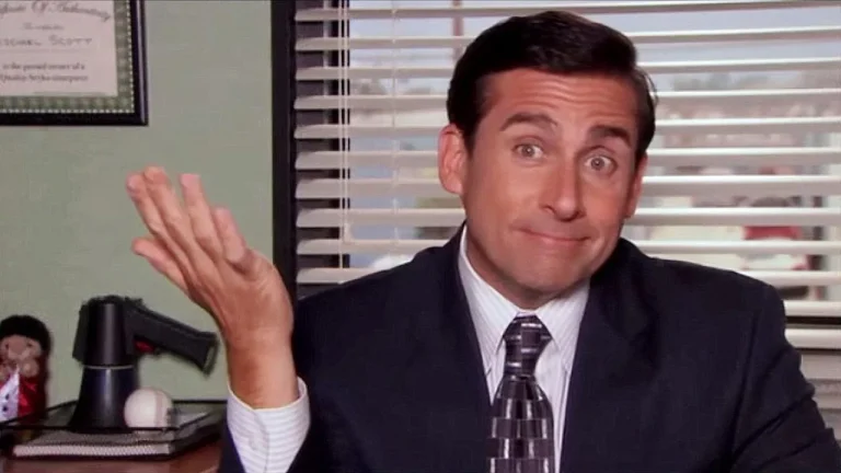 Michael Scott from ‘The Office’ giving a clueless shrug in his office, capturing the chaos of awkward workplace moments and hilariously dumb moments at work.