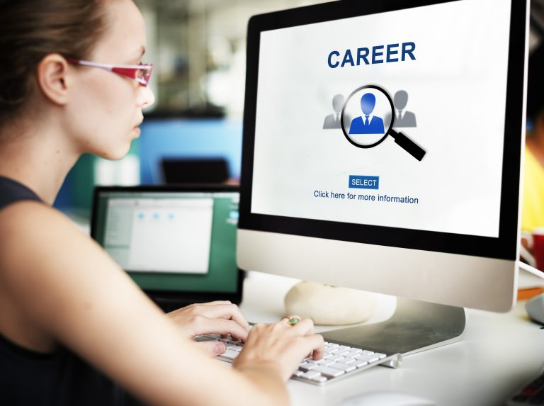 Woman browsing a tech careers and recruitment webpage on a desktop computer, illustrating online hiring platforms and digital talent acquisition in the European tech industry.
