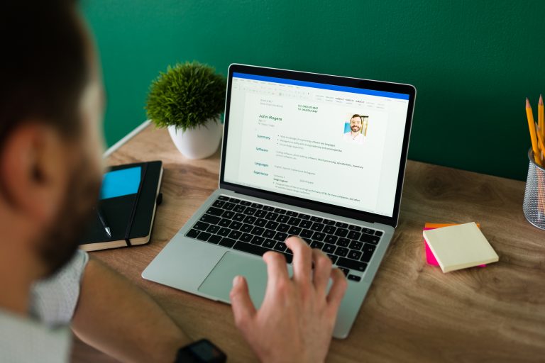 Still Keeping CVs in Email? That Could Be a GDPR Problem Tech recruiter reviewing a candidate resume on a laptop at a desk. The picture represents talent acquisition and candidate screening.